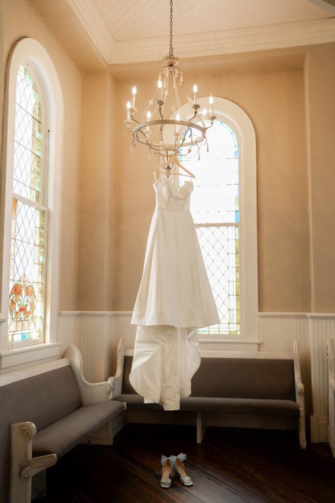 Wedding Dress hanging from chandelier at The 1906 Venue in Whitesboro
