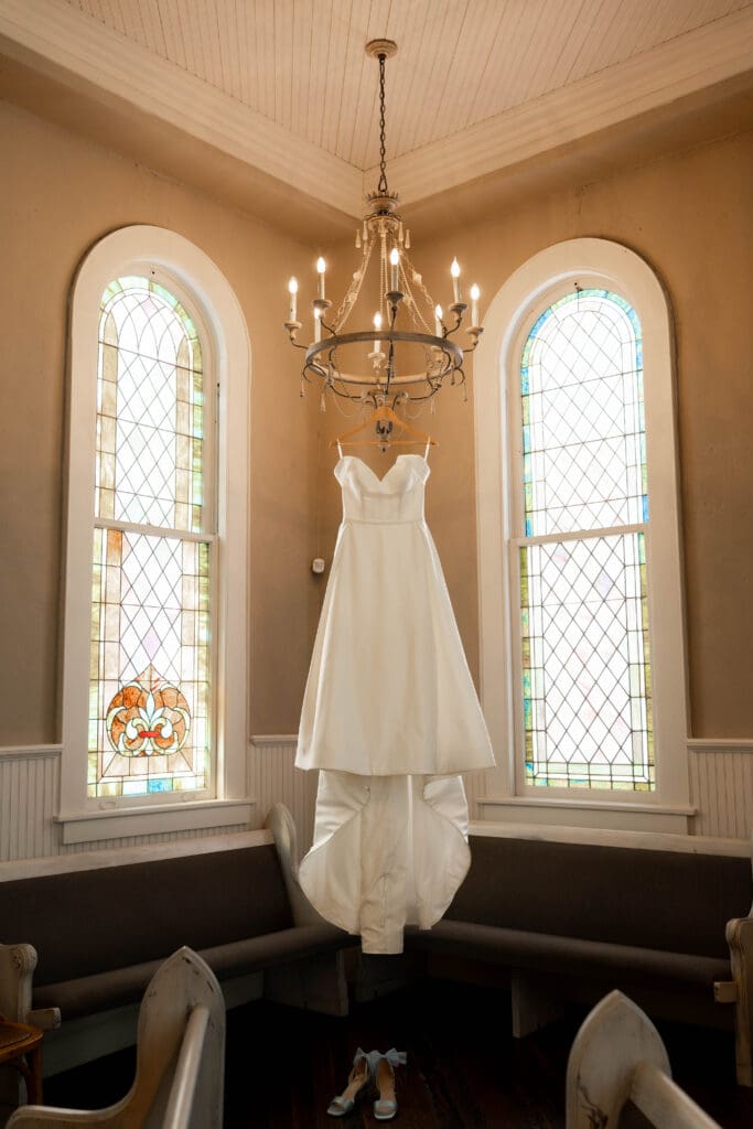 Wedding Dress hanging from chandelier at The 1906 Venue in Whitesboro