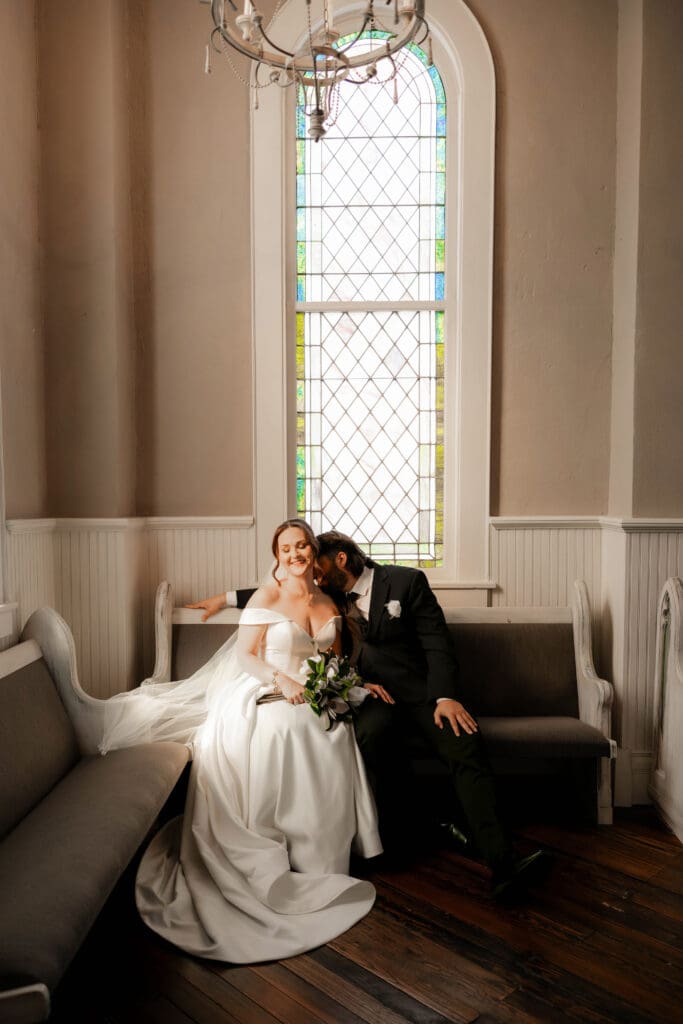 Bride and groom cuddling at The 1906 Venue in Whitesboro during wedding photography