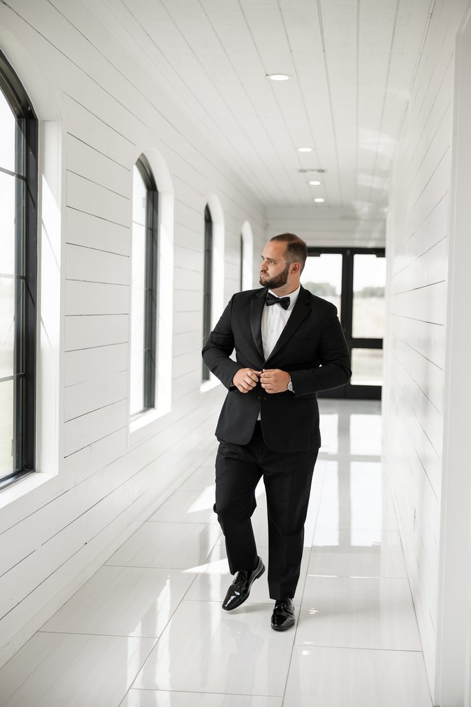 Groom walking inside The Gardenia wedding venue, one of the best wedding venues in Dallas Fort Worth