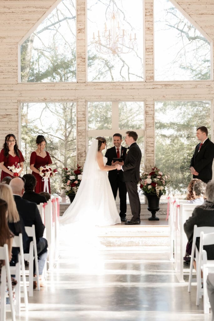 Bride and groom exchange vows at Soli Deo Gloria Weddings and Events in Decatur, TX