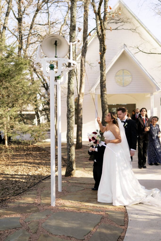 Bride rings the church bell at Soli Deo Gloria Weddings and Events in Decatur, TX