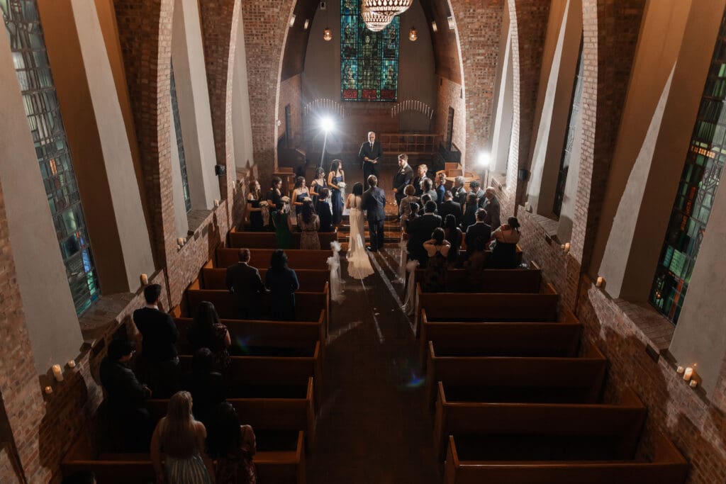 Creative low-light wedding portrait of couple with off-camera flash at Little Chapel in the Woods