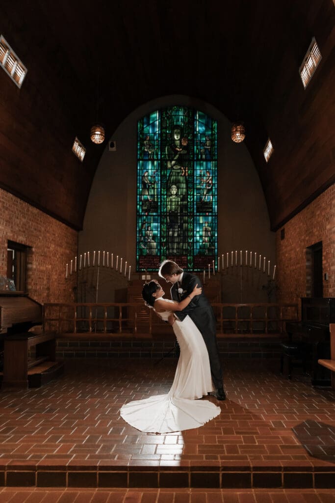 Creative low-light wedding portrait of couple with off-camera flash at Little Chapel in the Woods