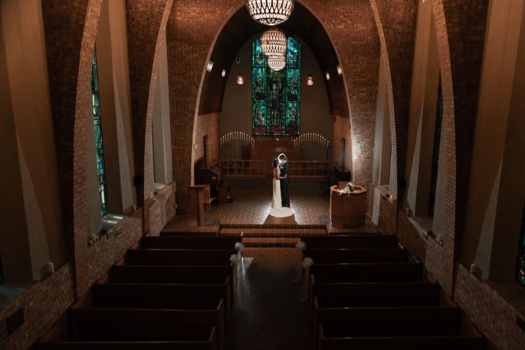 Creative low-light wedding portrait of couple with off-camera flash at Little Chapel in the Woods