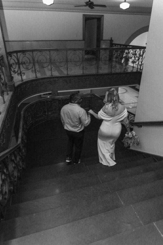 Bride and groom descending the stairs during their intimate Tarrant County Courthouse wedding.