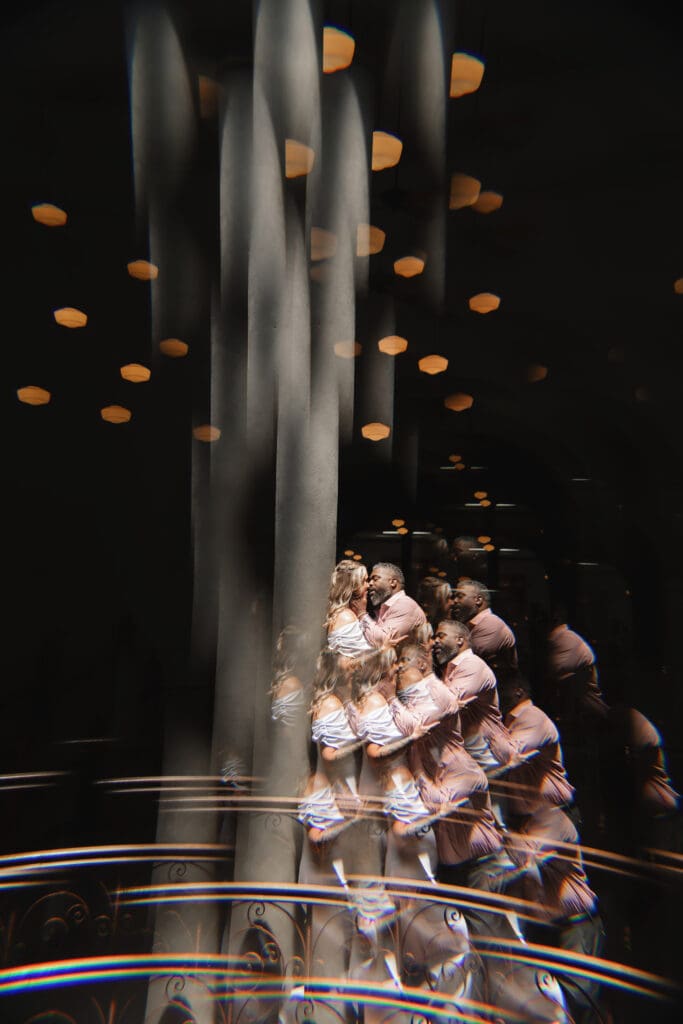 Moody, creative portrait of a couple kissing inside the Tarrant County Courthouse during their elopement.