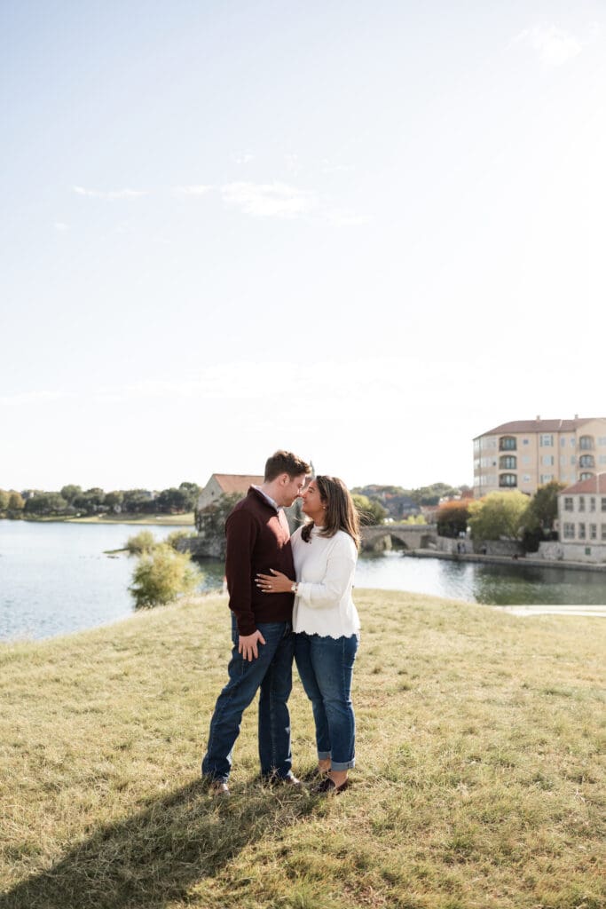 Couple walking hand in hand during Adriatica Village engagement photos in McKinney, TX