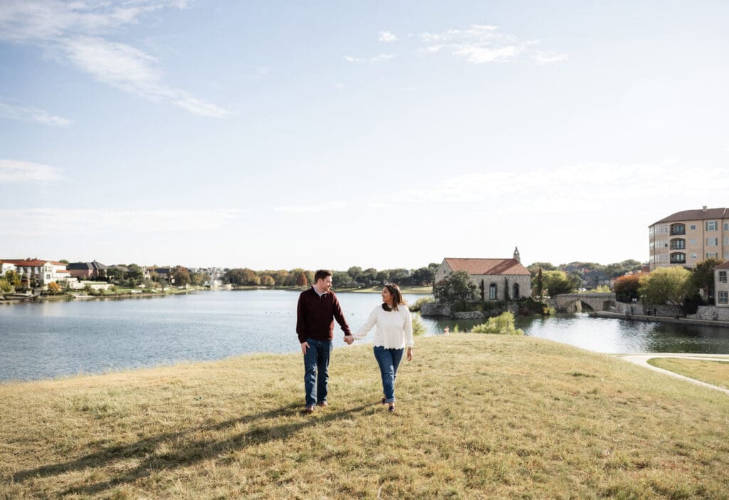 Couple walking hand in hand during Adriatica Village engagement photos in McKinney, TX