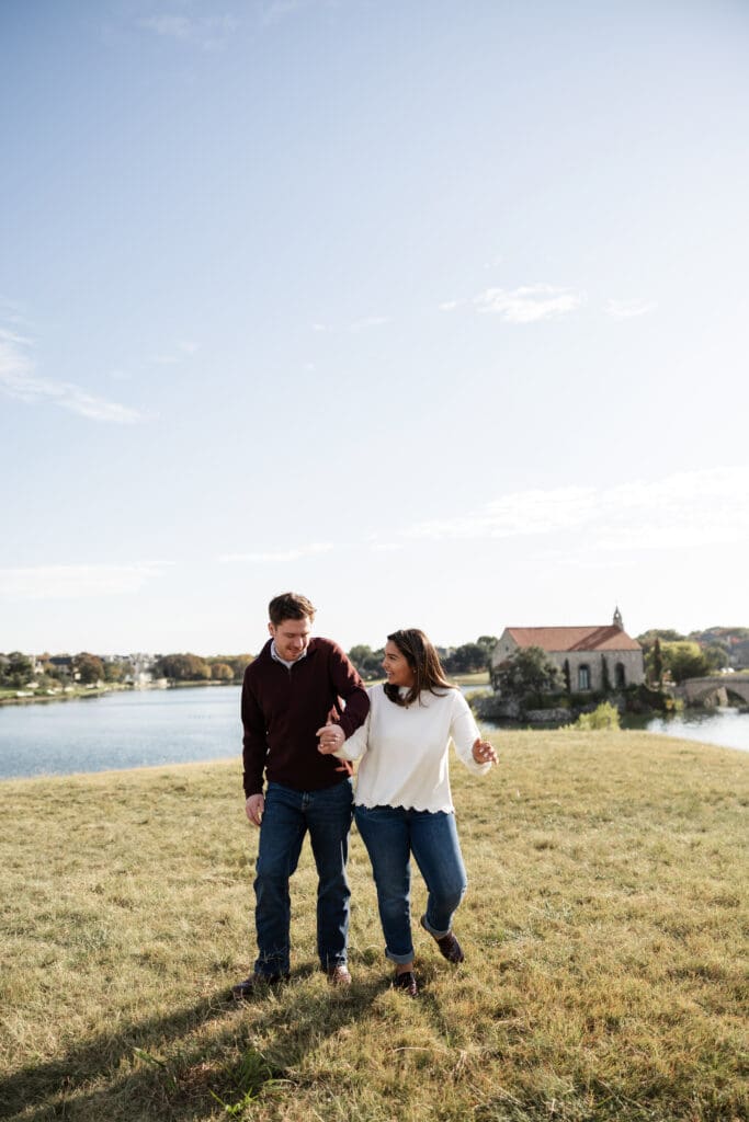 Couple walking hand in hand during Adriatica Village engagement photos in McKinney, TX