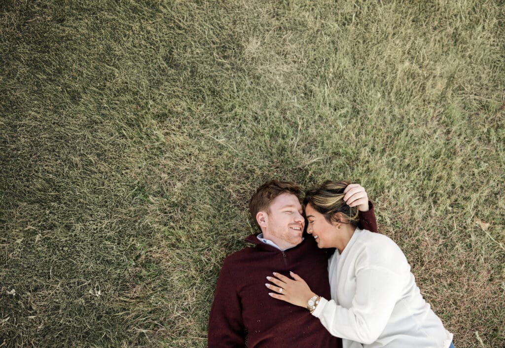 Engaged couple at Adriatica Village, McKinney Texas, embracing and enjoying golden hour engagement photos