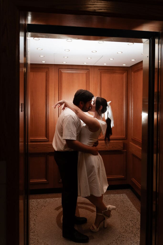 Couple kissing inside the courthouse elevator during their Fort Worth engagement photoshoot in downtown  Fort Worth