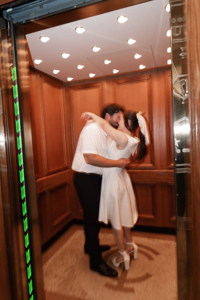 Couple kissing inside the courthouse elevator during their Fort Worth engagement photoshoot in downtown  Fort Worth