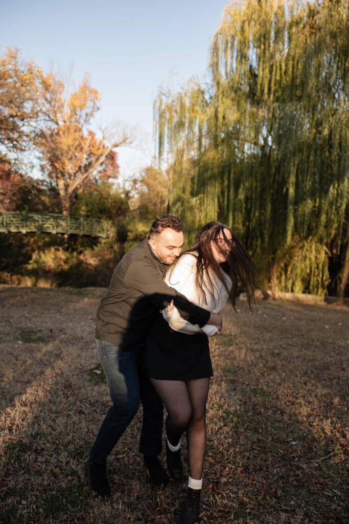 Engaged couple at Airfield Falls Park, Fort Worth, enjoying golden-hour engagement photos