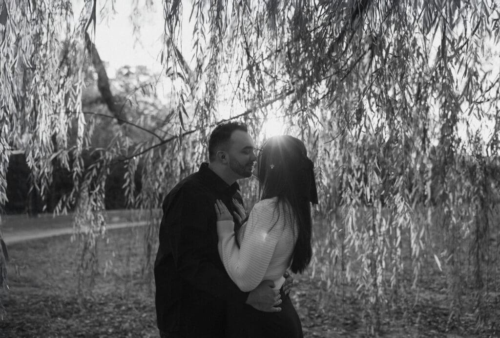 Engaged couple at Airfield Falls Park, Fort Worth, enjoying golden-hour engagement photos