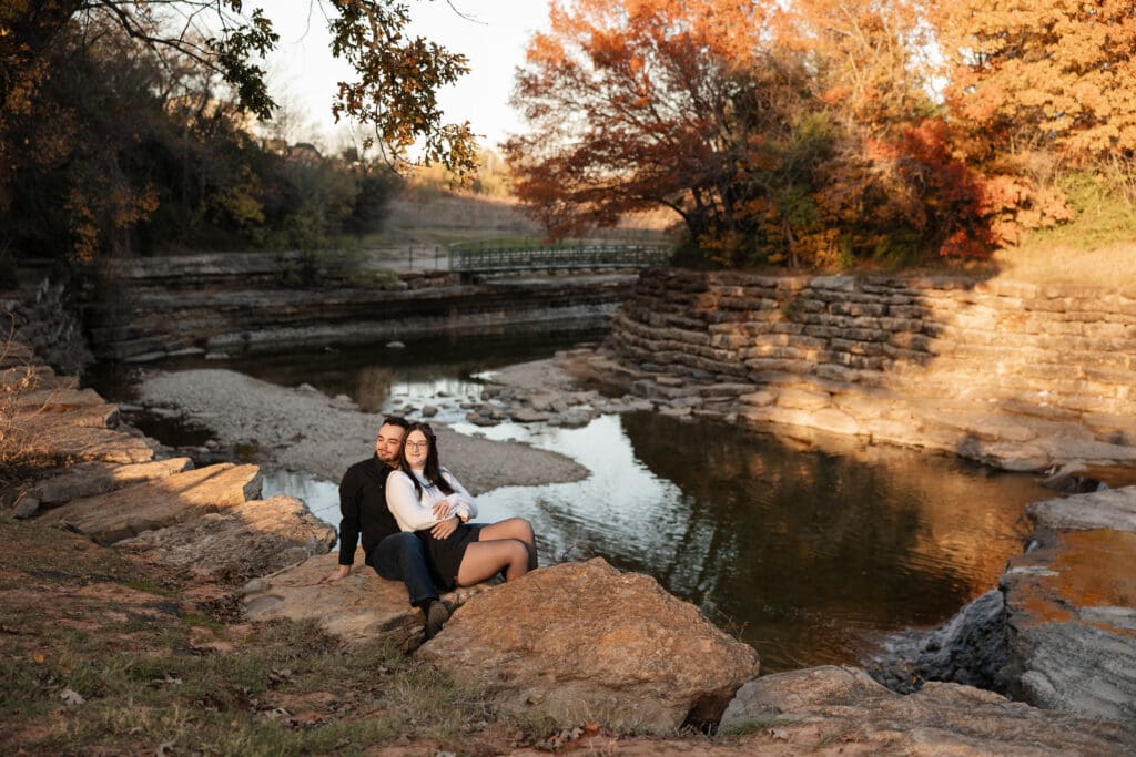 Engaged couple at Airfield Falls Park, Fort Worth, enjoying golden-hour engagement photos