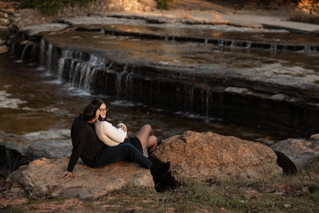 Engaged couple at Airfield Falls Park, Fort Worth, enjoying golden-hour engagement photos