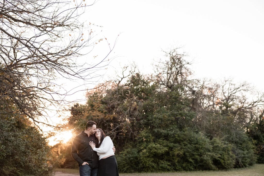 Engaged couple at Airfield Falls Park, Fort Worth, enjoying golden-hour engagement photos