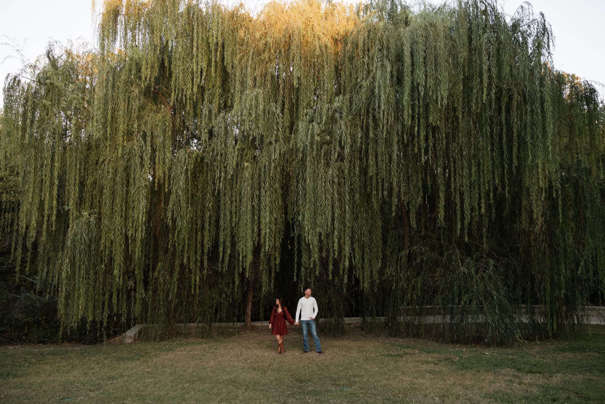 Engaged couple at Airfield Falls Park, Fort Worth, enjoying golden-hour engagement photos