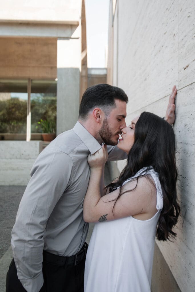 Engaged couple at Kimbell Art Museum, Fort Worth, embracing and flirting with each other