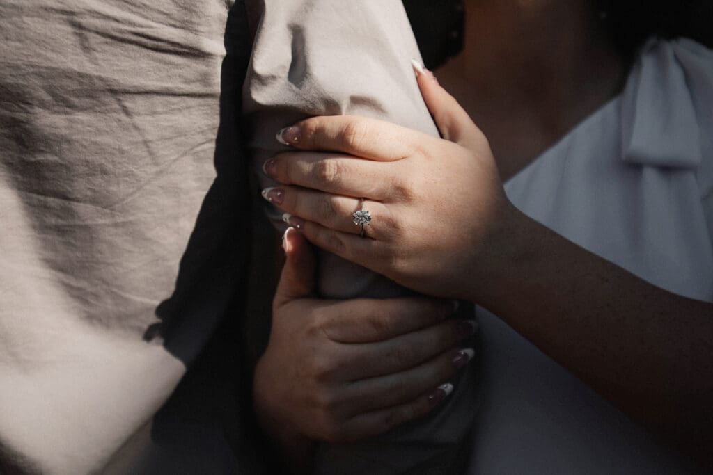 Engaged couple at the Water Gardens, Fort Worth, embracing each other during golden-hour engagement photos