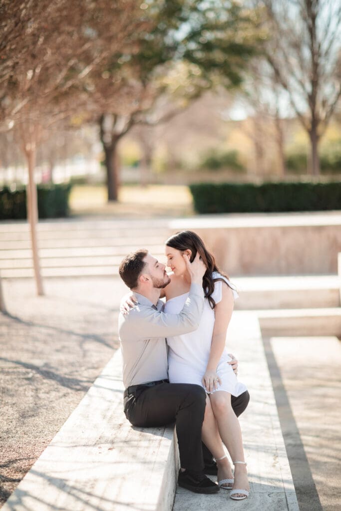 Engaged couple at Kimbell Art Museum, Fort Worth, embracing and cuddling