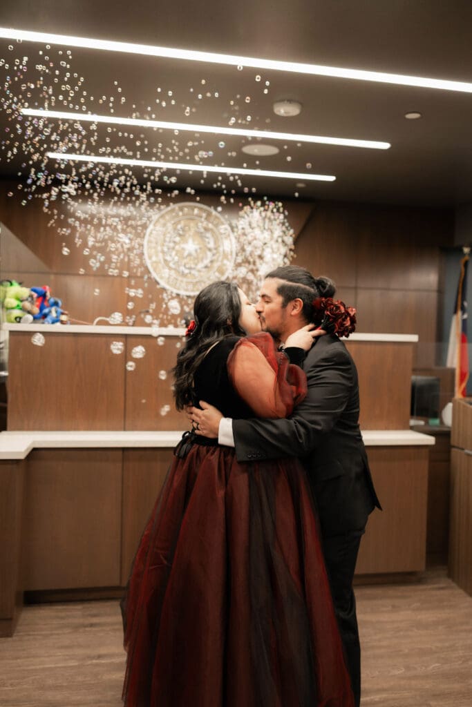 Judge Adam Swartz celebrating Esmeralda and Hector’s Dallas courthouse wedding with bubbles