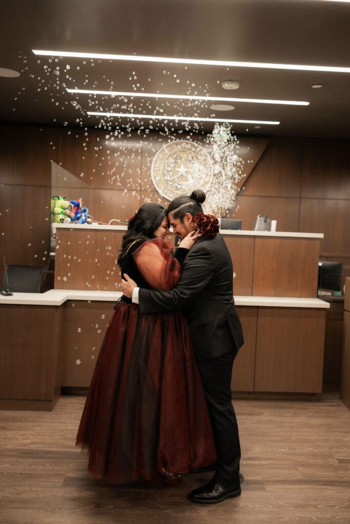 Judge Adam Swartz celebrating Esmeralda and Hector’s Dallas courthouse wedding with bubbles