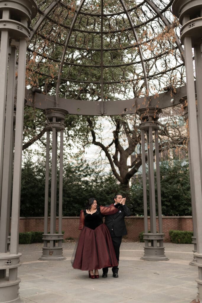 Esmeralda in black and red gown during Dallas courthouse wedding winter portraits at Turtle Creek Park