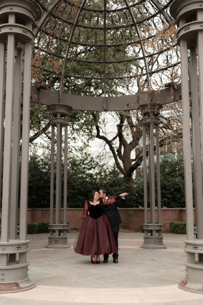 Esmeralda in black and red gown during Dallas courthouse wedding winter portraits at Turtle Creek Park