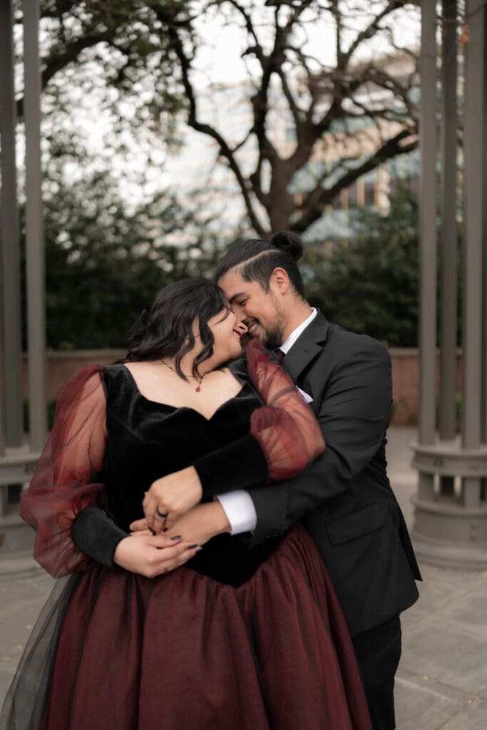 Esmeralda in black and red gown during Dallas courthouse wedding winter portraits at Turtle Creek Park