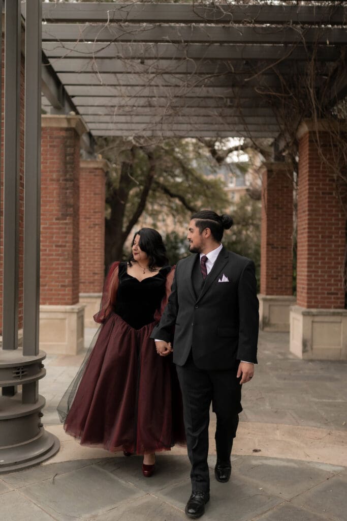 Esmeralda in black and red gown during Dallas courthouse wedding winter portraits at Turtle Creek Park
