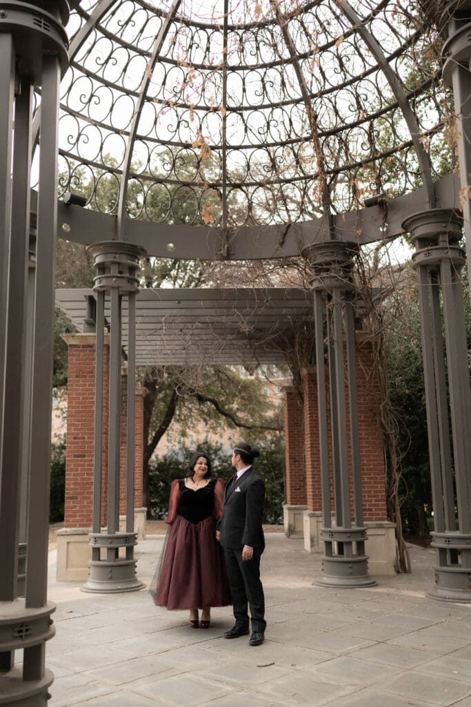 Esmeralda in black and red gown during Dallas courthouse wedding winter portraits at Turtle Creek Park