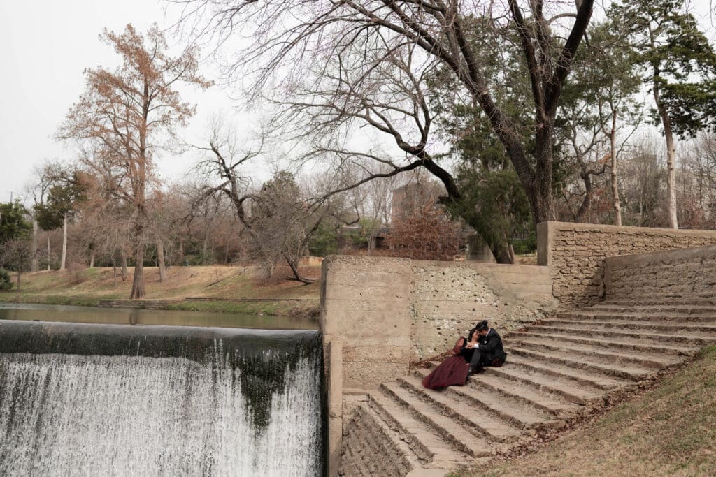 Esmeralda and Hector in front of the waterfall at Turtle Creek Park during their Dallas courthouse wedding