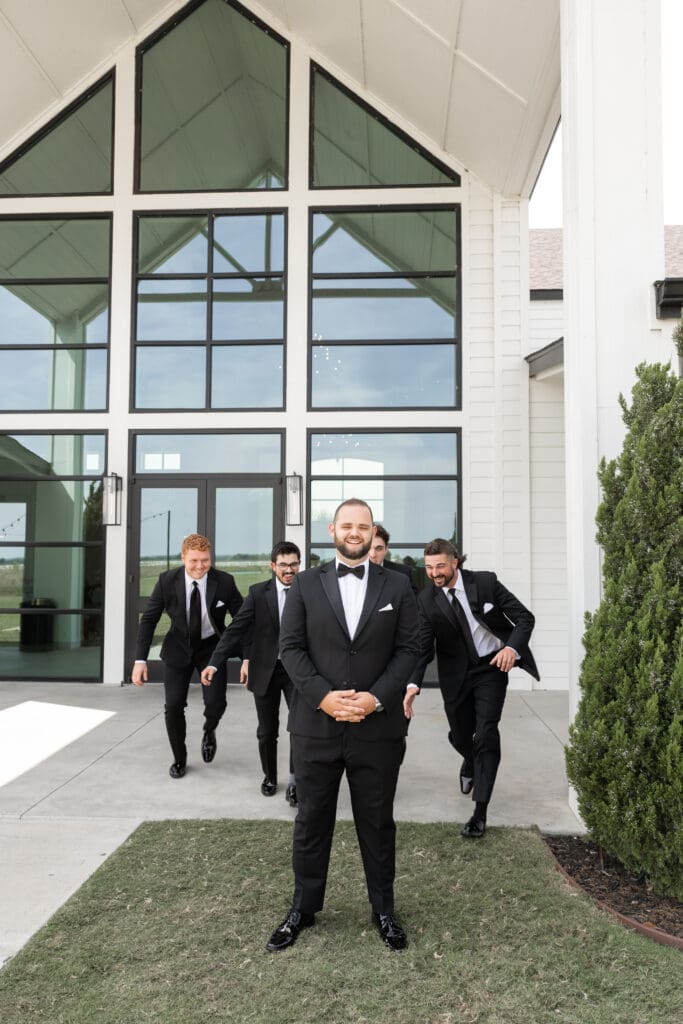 Groom's portraits with wedding party at The Gardenia Venue in Valley View, TX