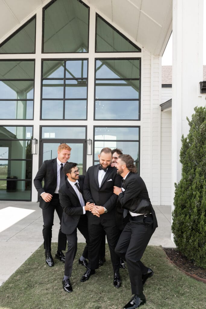 Groom's portraits with wedding party at The Gardenia Venue in Valley View, TX