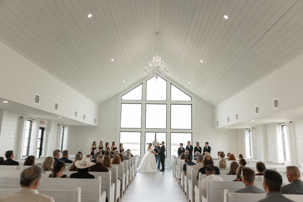 Bride and groom exchanging vows in the chapel at The Gardenia Venue in Valley View, TX