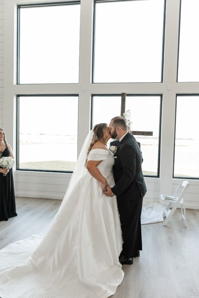 Bride and groom exchanging vows in the chapel at The Gardenia Venue in Valley View, TX