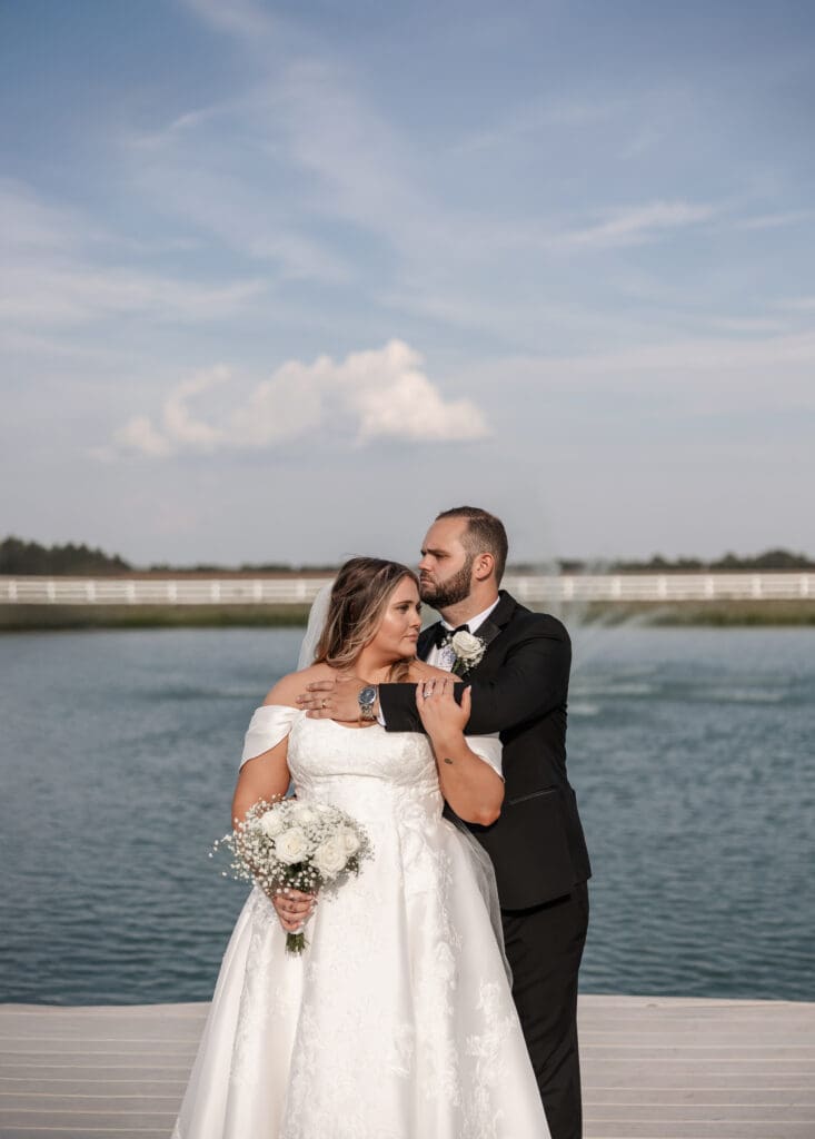 Bride and groom portraits along the pond at The Gardenia Venue in Valley View, TX