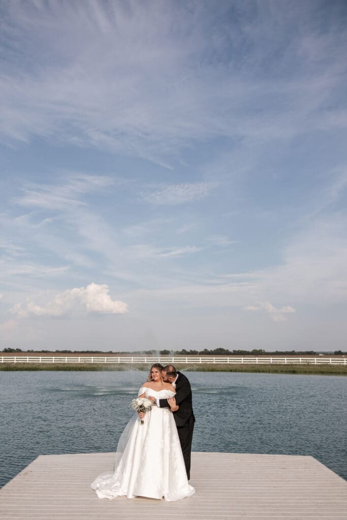 Bride and groom portraits along the pond at The Gardenia Venue in Valley View, TX