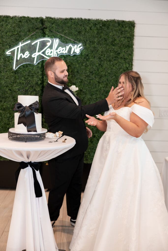 Bride and groom cutting wedding cake at The Gardenia Venue in Valley View, TX