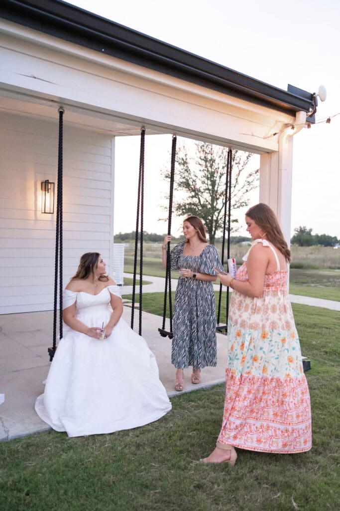 Wedding guests swinging at The Gardenia Venue in Valley View, TX