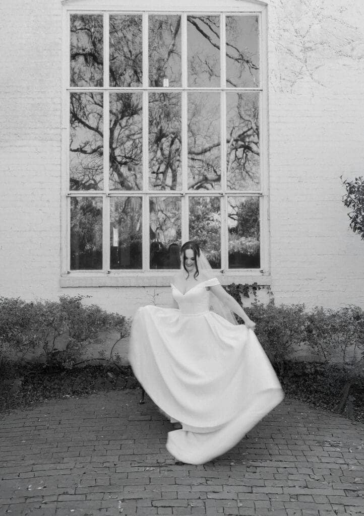 Moody, cinematic portrait of a bride dancing at Chandor Gardens in Weatherford, TX