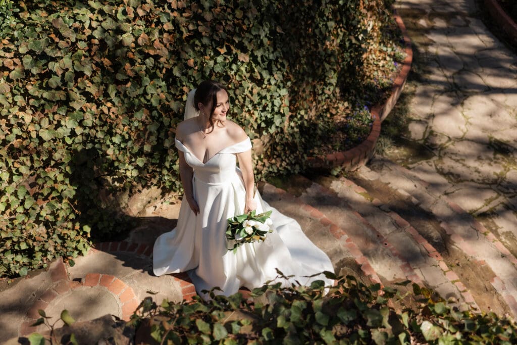 Moody portrait of a bride along a stone staircase