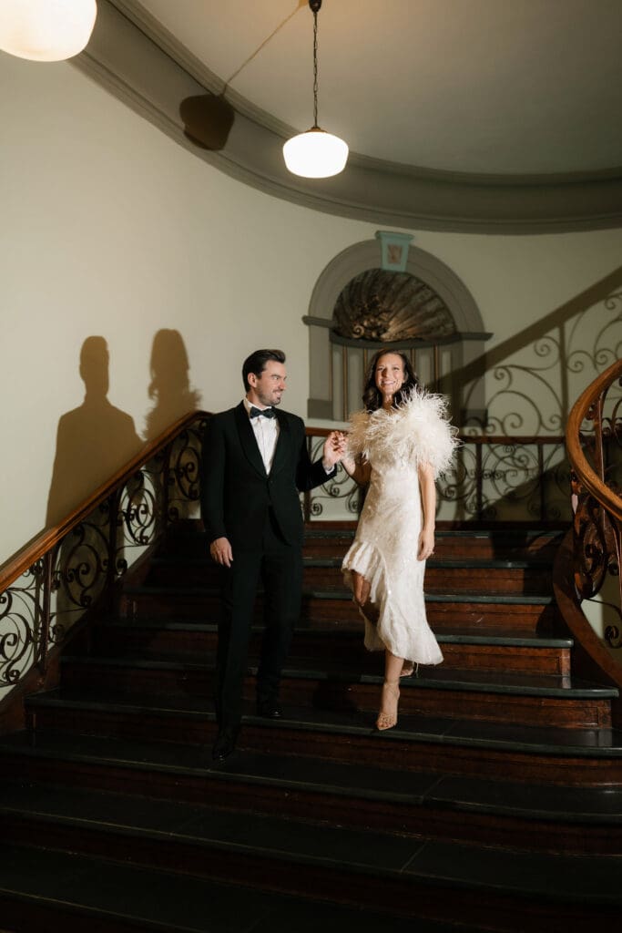 Woman and man walking down steps in the Fort Worth courthouse during their Fort Worth photo session
