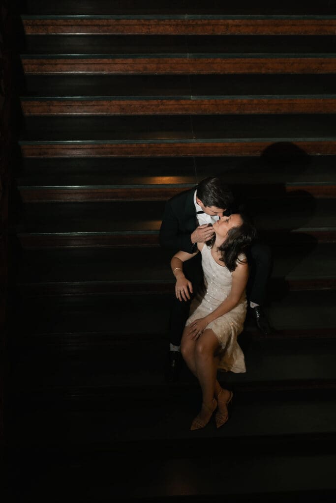 Woman and man cuddling on steps in the Fort Worth courthouse during their Fort Worth session