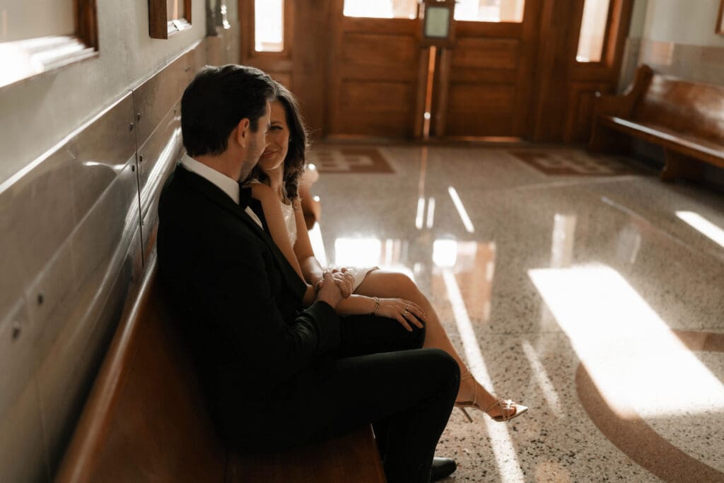 Woman and man cuddling on in the Fort Worth courthouse during their Fort Worth session