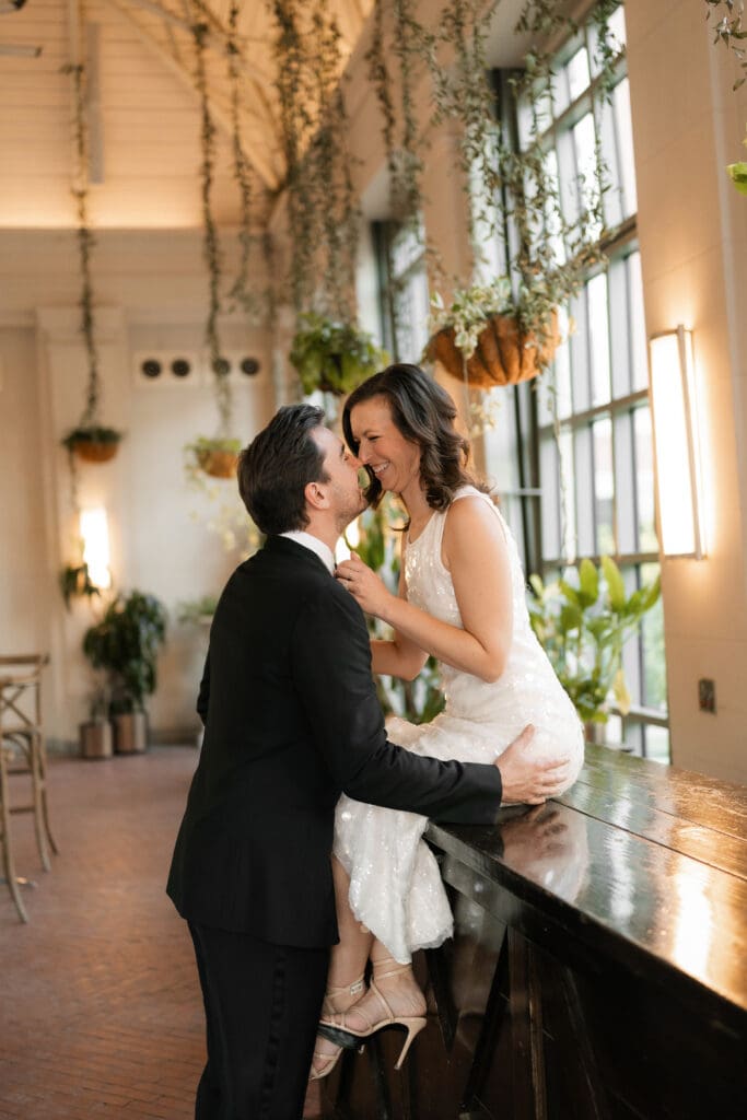 Woman and man cuddling inside the Sundance Square Pavilion greenhouse 
