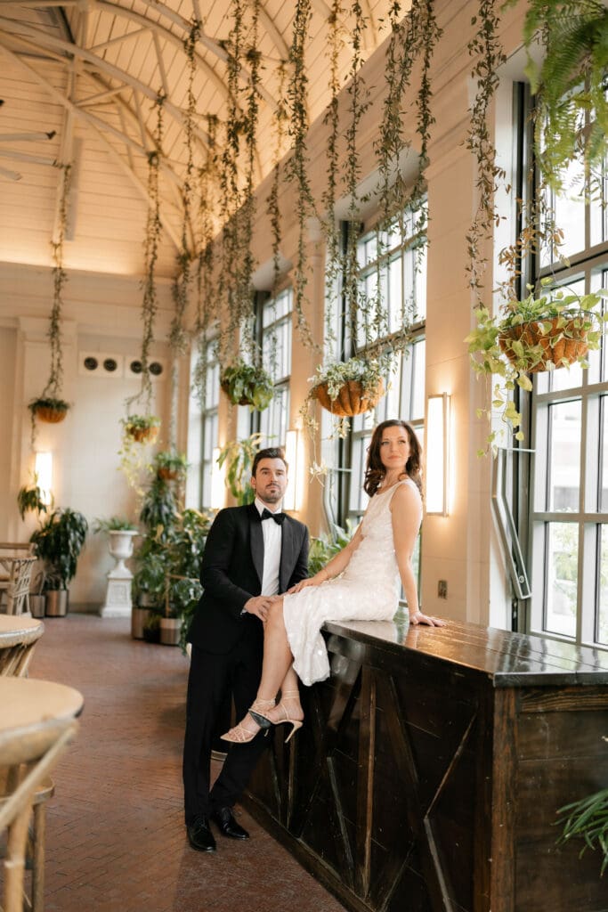 Woman and man cuddling inside the Sundance Square Pavilion greenhouse 