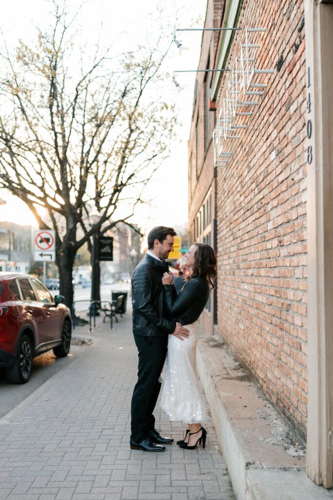 Woman and man cuddling outside the The Usual bar in Fort Worth